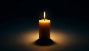 A-single-smooth-beeswax-candle-burning-in-the-darkness.-The-candle-is-elegant-and-minimalistic-emitting-a-warm-soft-glow-that-illuminates-its-immediate space
