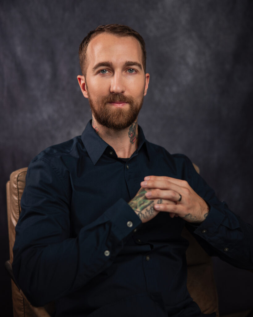 The-best-tarot-reader-in-the-world-Chris-Bennett-based-out-of-Vancouver-British-Columbia-Canada. Sitting in chair for a professional studio photo with Michael Aaron Keith photographer in Vancouver British Columbia