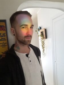 The-worlds-best-tarot-reader-Chris-Bennett-based-out-of-Vancouver-Canada 35yr old psychic medium with rainbow prism on face from sun catcher