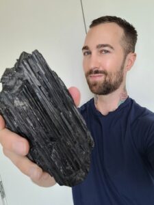 The-best-tarot-reader-in-the-world-Chris-Bennett-holding-a-piece-of-black-tourmaline-to-reduce-fear-and-anxiety