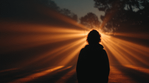 A person bathed in golden morning light, standing in fog, symbolizing awakening and the return of the soul after death.