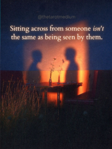  Sitting across from someone isn't the same as being seen by them. Two silhouettes sitting across from each other at dinner with a sense of vacancy despite warm light, representing emotional unavailability in relationships discussed by a psychic medium.