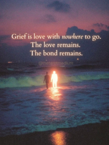 Two human figures in ocean surf at dusk, one illuminated spirit and one earthbound soul, representing grief and continued love after death