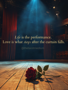 Life is the performance. Love is what stays after the curtain falls. An empty theatrical stage viewed from the wings with a single spotlight on worn floorboards and red velvet curtains parted, representing the psychic medium perspective that life is a stage and we meet each other backstage.