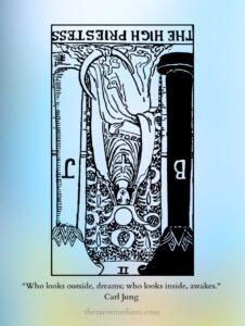 The High Priestess tarot card reversed, the veil and scroll inverted for secrets, withheld truth, and intuition overruled. You already know. The quiet is where you hear it.