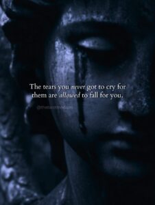 A stone statue of a woman with tear stains down her face, carrying the quote "The tears you never got to cry for them are allowed to fall for you." From The Tarot Medium on mourning who you could have been.